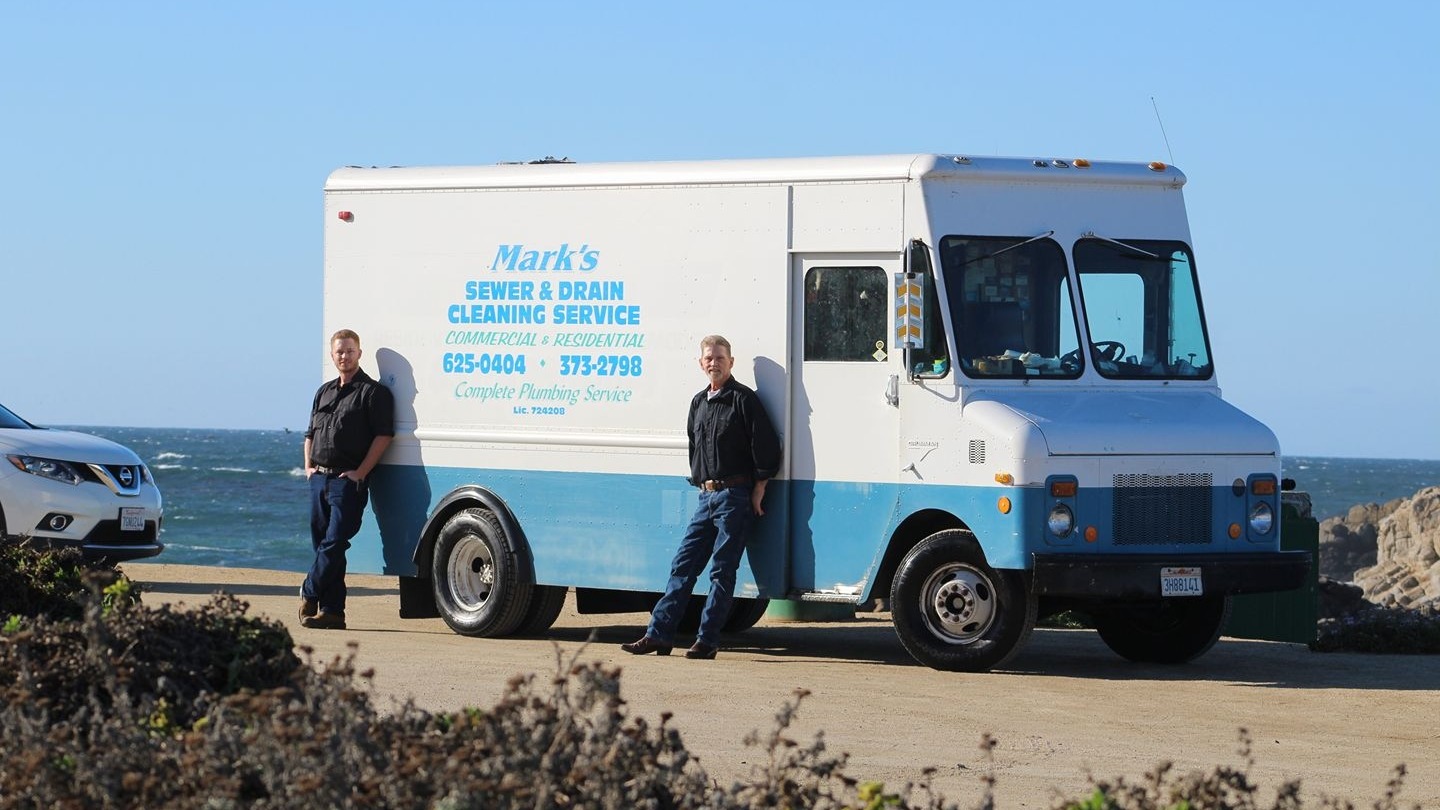 Mark and his father beside the Mark's Sewer & Drain service van at Asilomar